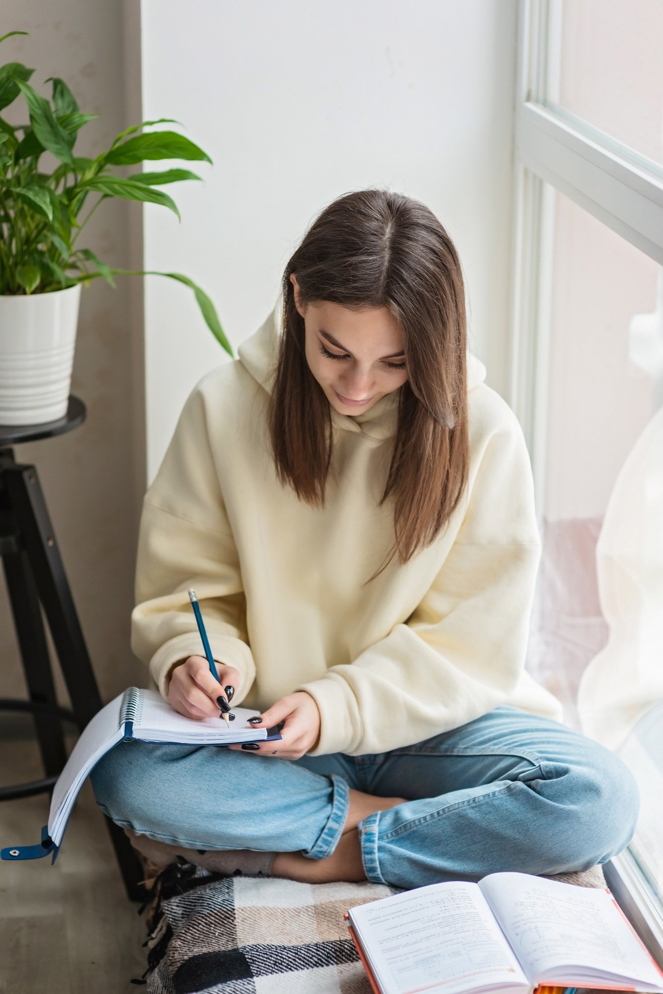 A teenage girl is preparing for exams remotely at home. Home schooling, education.